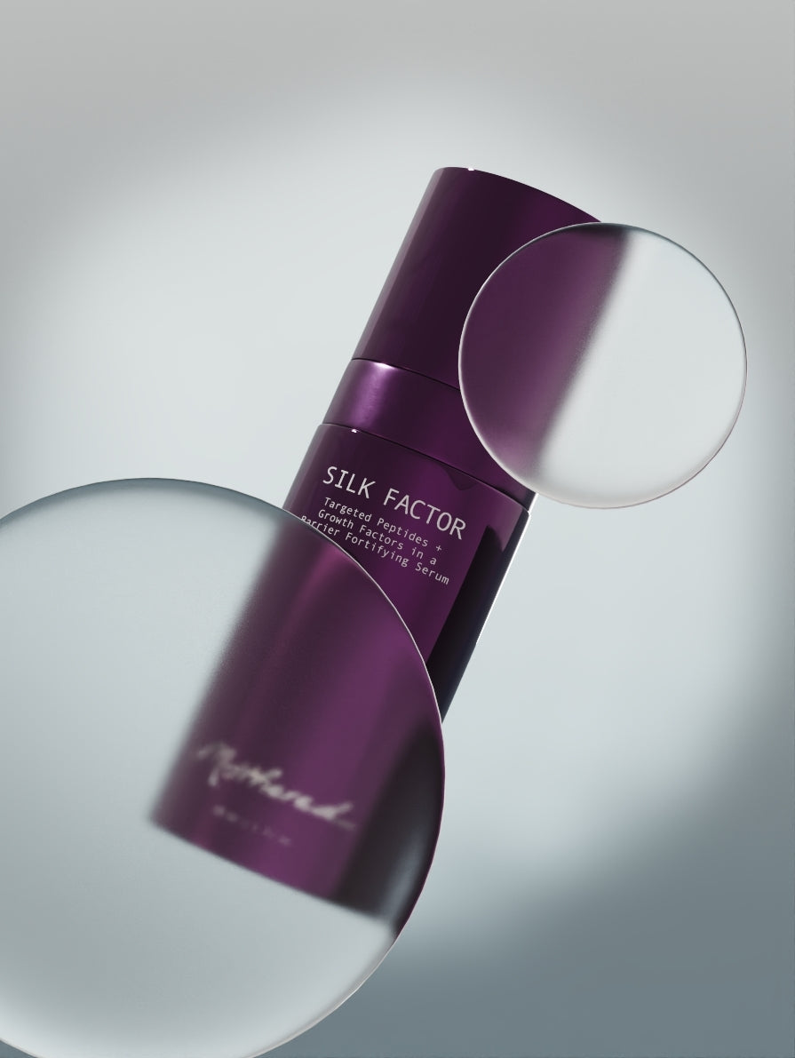 Purple skincare serum bottle labeled 'Silk Factor' on a reflective surface.